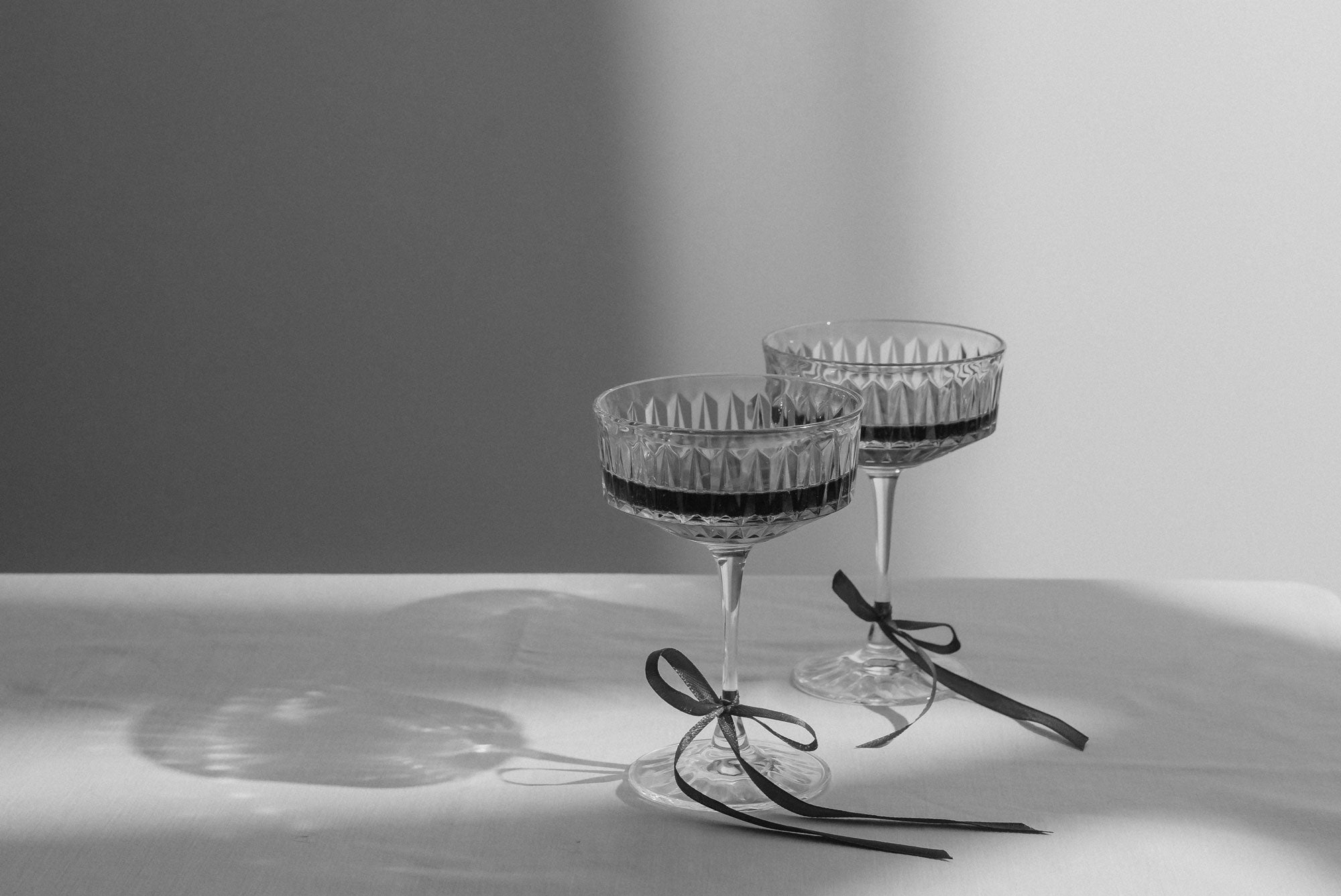 kaboompics_elegant-toast-vintage-wine-glasses-with-red-ribbon-accents-34633.jpg